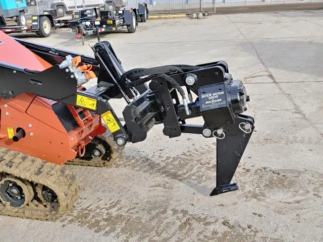 A tractor with a plow attachment on the back of it.