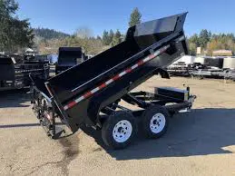 A dump trailer is parked in the lot.