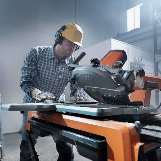 A man in yellow hard hat using circular saw.