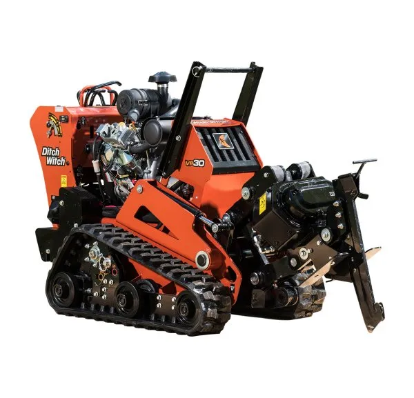 A small orange and black machine is on the ground