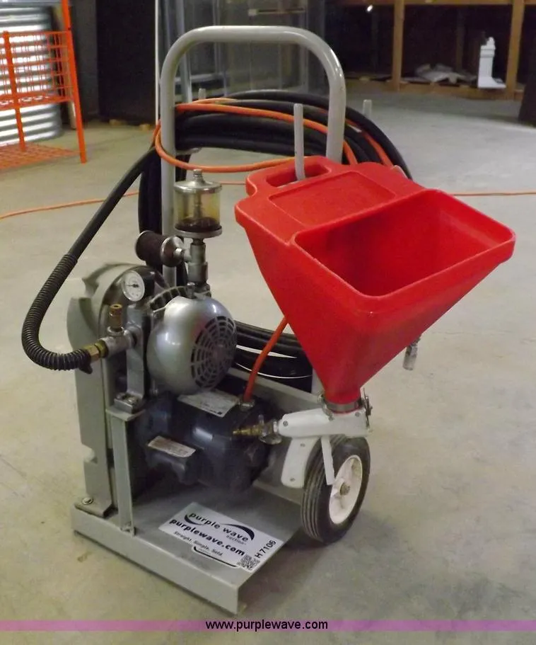 A red cart with a hose attached to it.