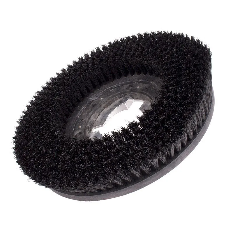 A black brush is on top of the floor.