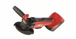 A red and black angle grinder is on the floor