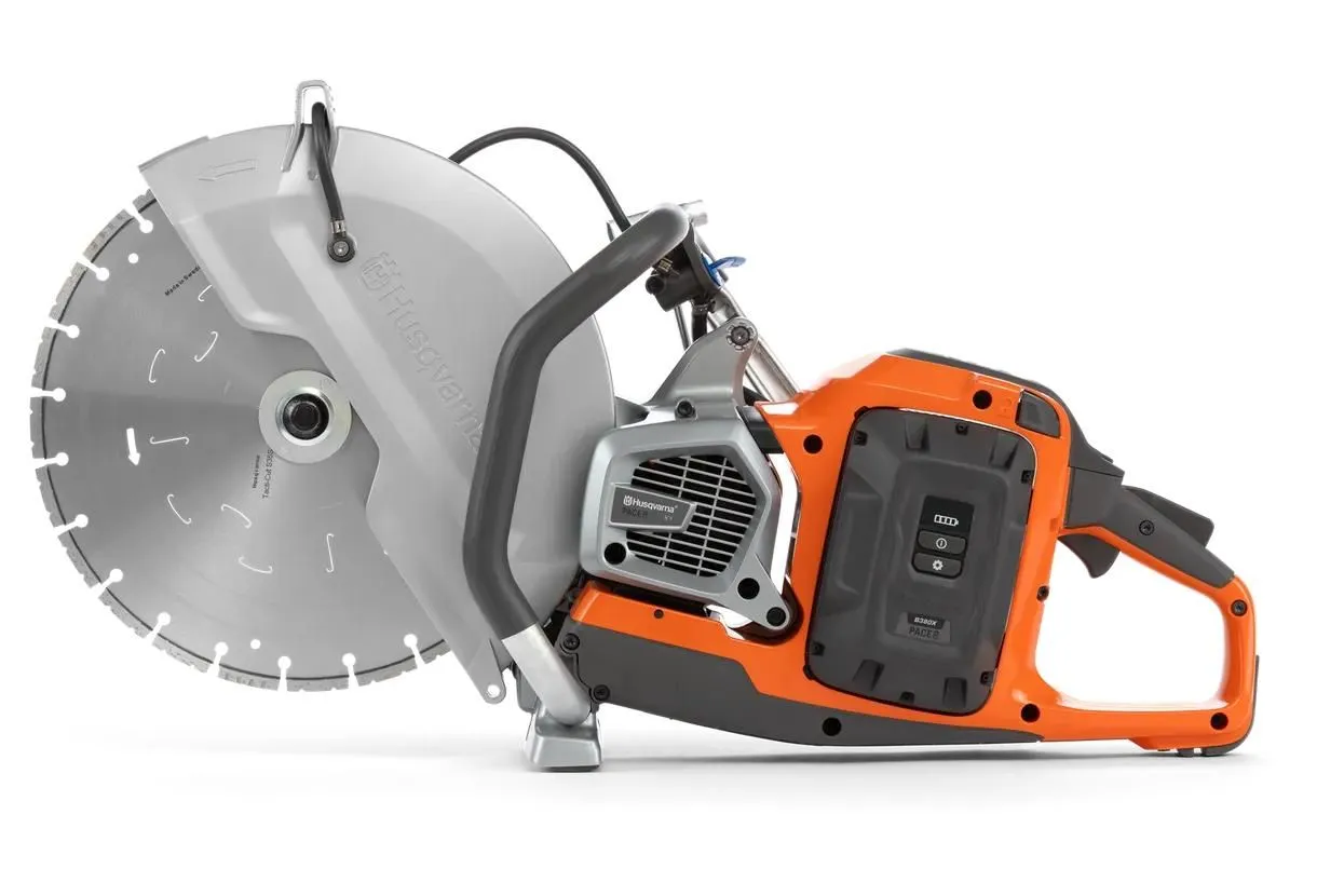 A close up of an electric saw on the ground