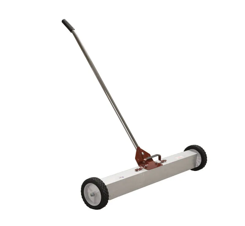 A white and black floor sweeper with handle.