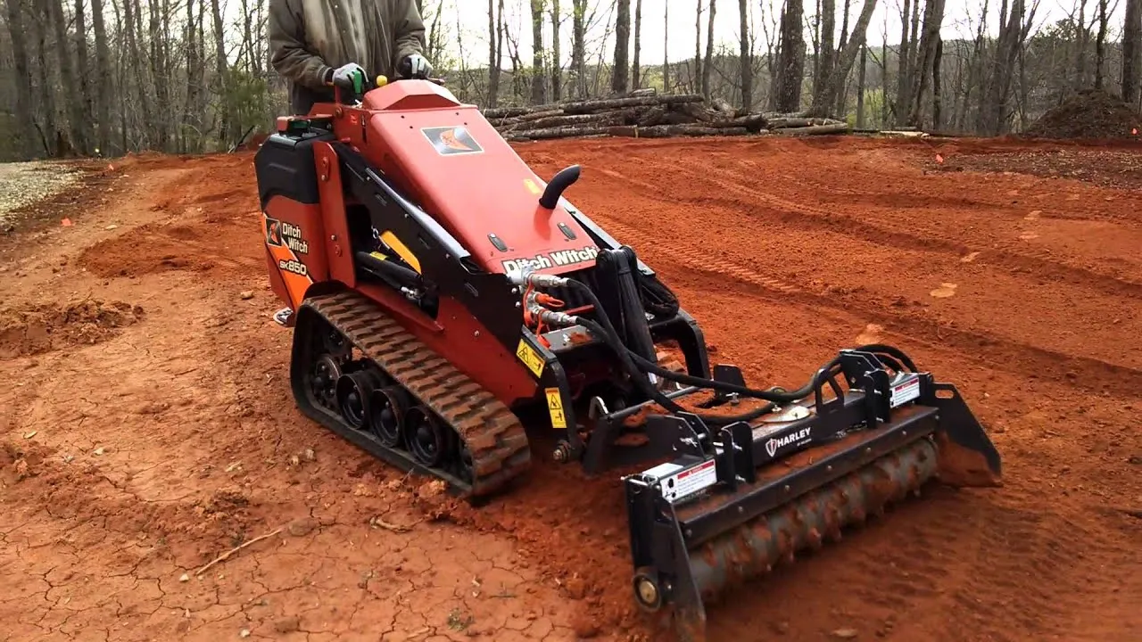 A red and black tractor is on the ground