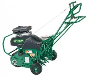 A green and black lawn mower with a handle.