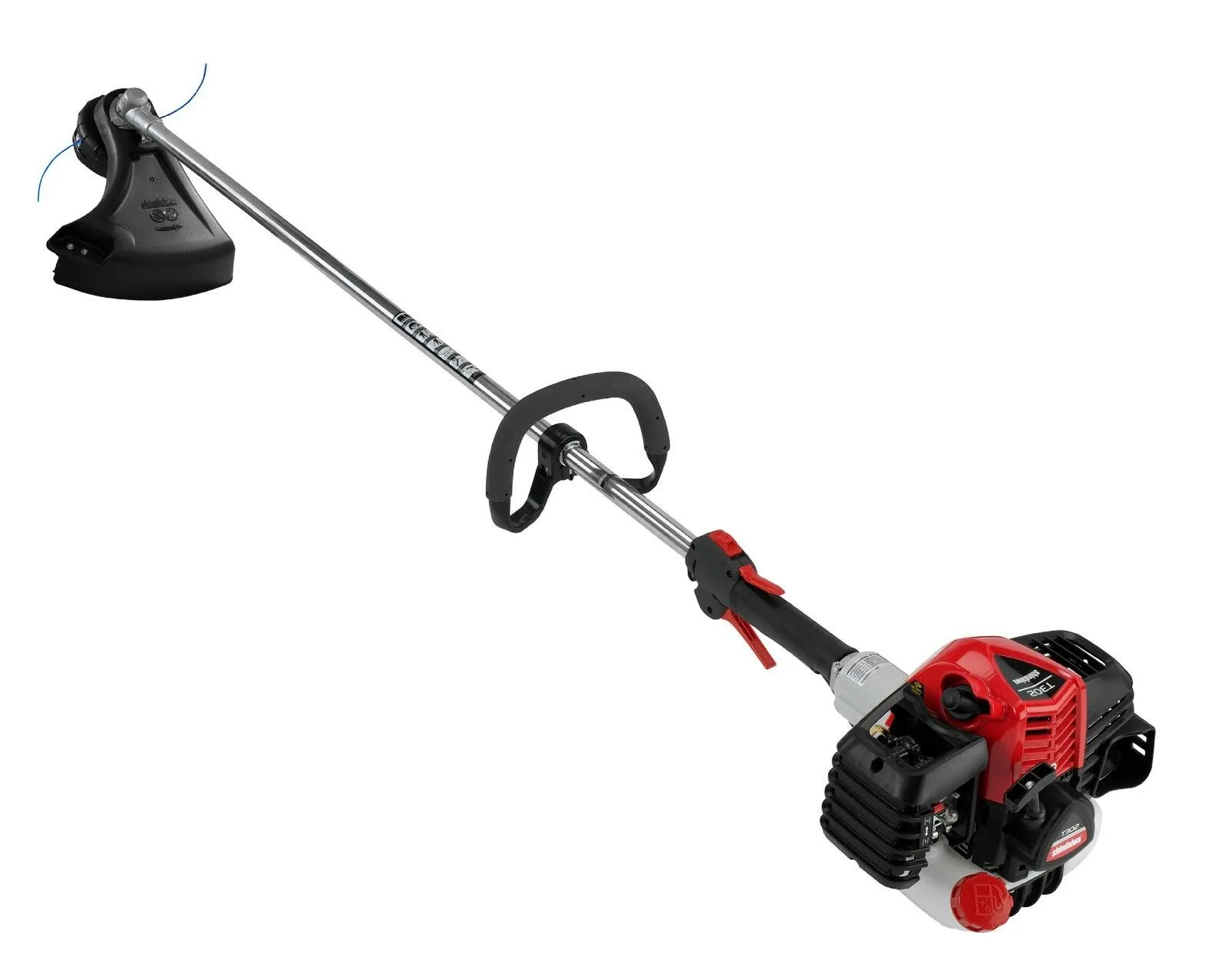 A red and black trimmer is on the ground