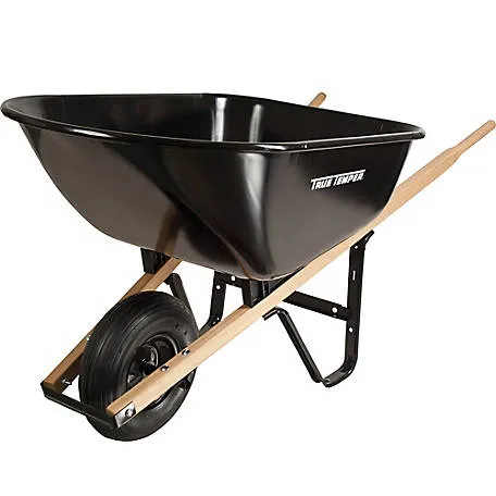 A black wheelbarrow with wooden handles and wheels.